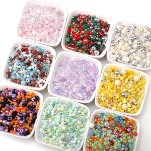 Detailed view of nine assorted colorful DIY glass bead sets for jewelry making kits