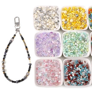 Detail showing colorful DIY glass seed beads set with a finished beaded keychain lanyard