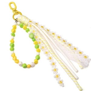 Detail of floral lace tassel pendant with yellow heart beads for handmade jewelry