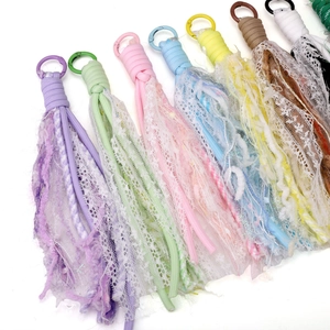Detailed close-up of colorful polyester lace flower tassel pendants for DIY jewelry making