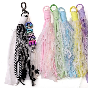Detailed view of colorful polyester lace tassel keychains with bohemian braided textures