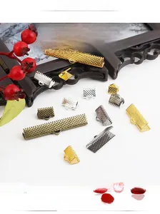 Close-up of assorted metal ribbon crimp ends with textured surface for DIY jewelry making