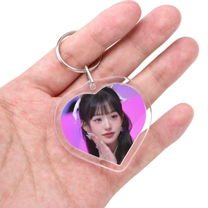 Close-up of heart-shaped transparent acrylic keychain holder with celebrity photo insert