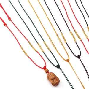Hand-woven nylon necklace cords with carved wood pendants in various colors