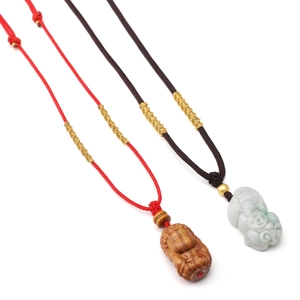 Handwoven nylon cord necklace with carved wood and jade pendants in traditional style