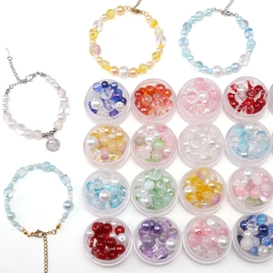 DIY jewelry kit with colorful glass beads and finished beaded bracelets with shell charms