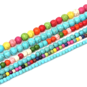 Detailed macro view of 4mm and 10mm colorful synthetic turquoise beads for DIY jewelry making