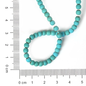 Polished 4mm turquoise loose beads for DIY jewelry making on white background with scale
