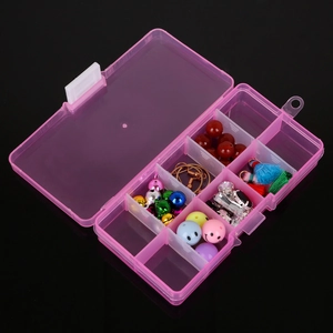 Organizador de joyas rosa con 10 compartimentos que incluye cuentas de colores y dijes