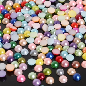 Macro view of assorted colorful semi-round flatback faux pearls for DIY crafts and nail art