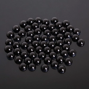 Detailed close-up of polished black semi-round ABS faux pearl beads for DIY crafts