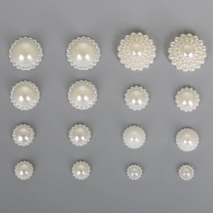 Flat lay of assorted white ABS pearl charms with scalloped edges for DIY hair accessories