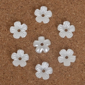 Macro detail of white pearl finish flower spacer beads for DIY hair accessory making