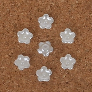 Macro shot of seven pearl white ABS resin flower charms for DIY hair accessories