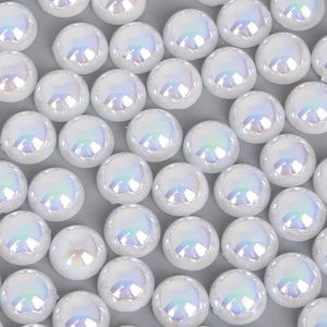 Detailed close-up of iridescent AB white flatback half pearls for DIY crafts and jewelry