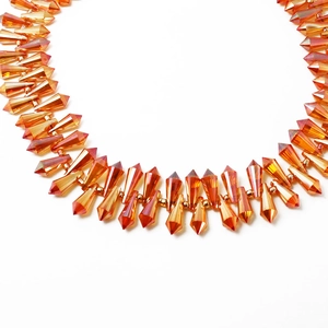 Amber faceted teardrop crystal beads with gold accents in a tassel fringe arrangement