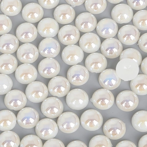 Macro shot of iridescent ivory flatback half pearls for DIY crafts and nail art