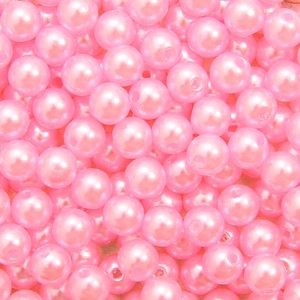 Macro detail of bright pink polished round ABS acrylic faux pearls for DIY jewelry making