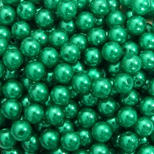 Macro shot of emerald green round acrylic pearls with center holes for DIY jewelry making