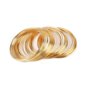 Macro shot of gold-plated multi-layer stacking wire bracelets in minimalist style