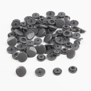 Detail view of gray resin snap buttons showing a complete set of four components on white background