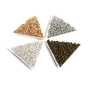 Close-up of four colors iron spacer beads for DIY jewelry making in trays