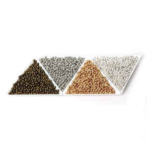 Macro detail of round metal spacer beads with large holes in four assorted metallic colors