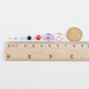 Multi-color faceted crystal glass beads set with ruler and coin for size scale reference
