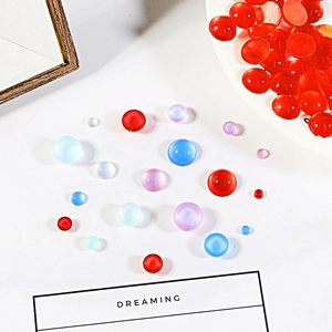 Close-up of assorted colorful round resin cat-eye beads for DIY jewelry and hairpins