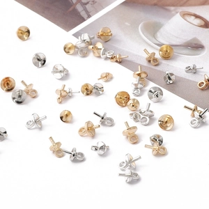 Macro detail of copper pearl peg bails with eye pins for DIY jewelry making in gold and silver