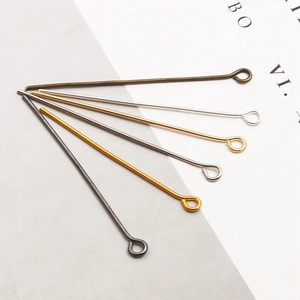 Macro detail of various metallic finish eye pins for DIY jewelry making and beading