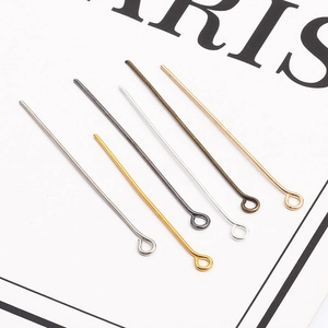 Macro shot of 9-shaped metal eye pins in six diverse plating colors for DIY jewelry making
