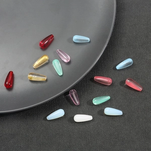 Colorful teardrop glass beads for DIY necklaces and bracelets on a black background