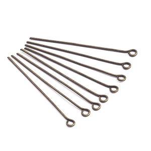 Macro view of eight antique bronze eye pins for DIY earring and jewelry making