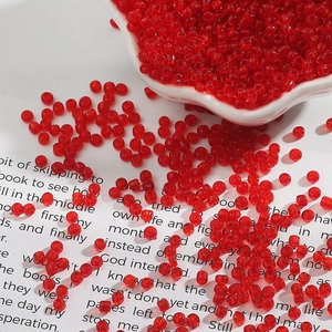 Macro shot of 2-3mm transparent red glass seed beads for DIY jewelry making