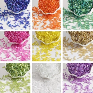 Assorted colorful glass bugle beads in petal bowls for DIY jewelry and embroidery