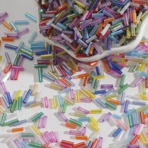 Macro shot of colorful iridescent glass bugle beads for DIY embroidery and jewelry crafts