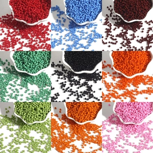 Detailed grid view of assorted colorful glass seed beads in small white ceramic bowls