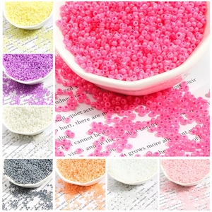 Macro shot of colorful iridescent round glass beads for DIY jewelry and handicraft making