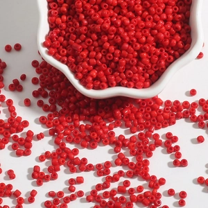 Macro detail of glossy solid red glass seed beads for DIY jewelry and necklaces