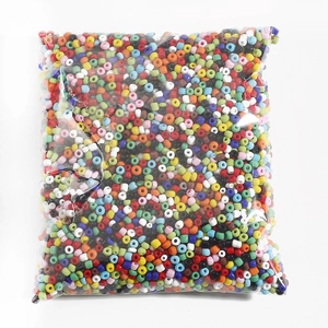 Assorted colorful DIY glass seed beads in bulk packaging for jewelry making projects