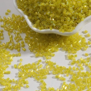 Macro view of 2mm transparent yellow glass bugle beads for DIY jewelry and sewing projects