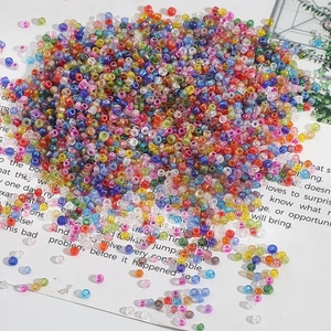 Macro shot of colorful transparent glass seed beads for DIY jewelry and embroidery crafts