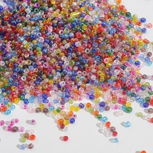 Macro shot of assorted colorful transparent glass seed beads for DIY jewelry making