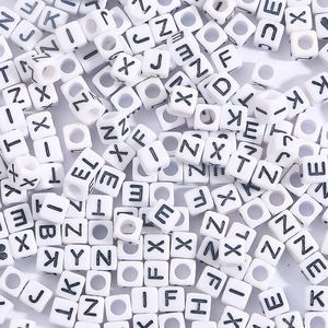 DIY acrylic alphabet cubes with black capital letters for educational jewelry making