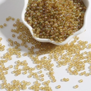 Macro detail of iridescent golden glass seed beads for DIY jewelry and bracelet making
