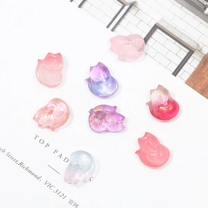 Macro view of gradient glass fox charms with gold foil inside for DIY hair pins