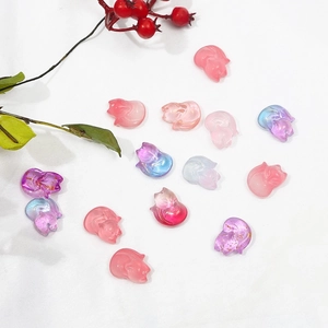 Macro detail of gradient glass fox beads with gold foil accents for DIY hair pins