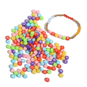 Macro detail of colorful acrylic letter beads and heart patterns for DIY jewelry making