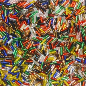 Macro close-up of colorful mixed tubular glass seed beads for DIY jewelry and sewing